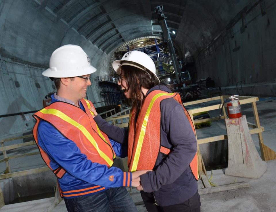 Workers in hard hats inside a tunnel