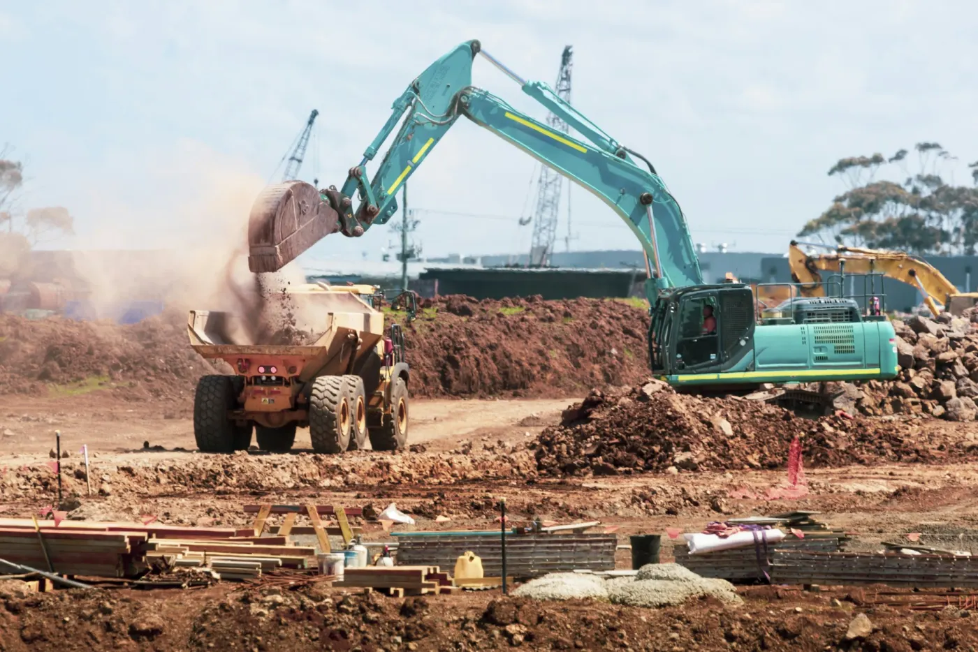 An excavator and trucks on a construction site
